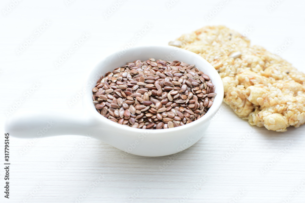 Natural sesame seeds on wooden background Natural sesame seeds on wooden background