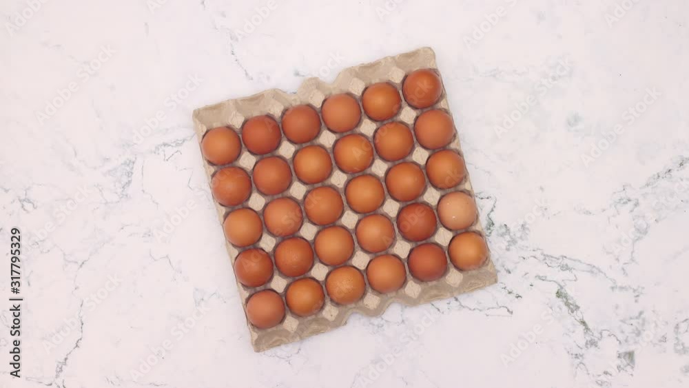 Box with eggs spin in circle on marble background - Stop motion Box with eggs spin in circle on marble background - Stop motion