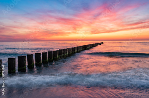 Baltic sea seascape at sunset  Poland  wooden breakwater and waves
