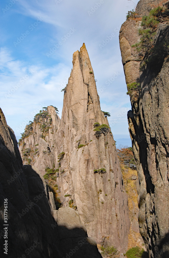 Huangshan Mountain in Anhui Province, China. Rocky pinnacle on Huangshan summit near Flying-Over Rock. View of rocks and cliffs on Huangshan Mountain, China.