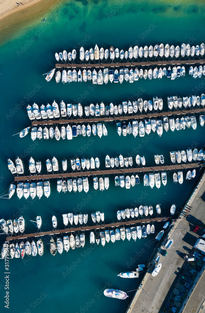 Top view of the Marina into the sea. Pier with boats parked near the shore