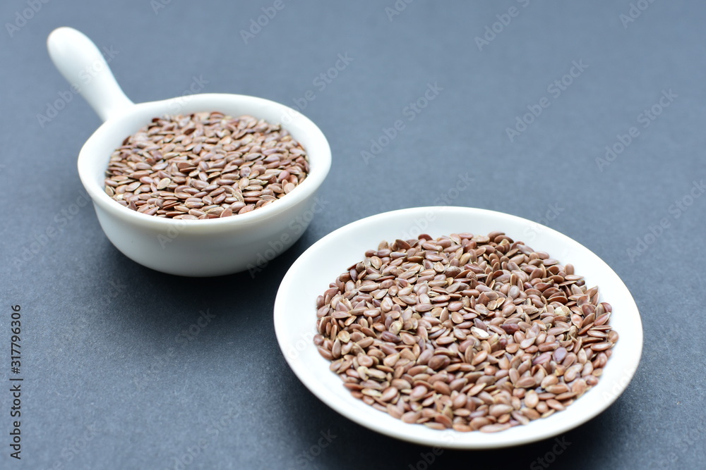 Natural sesame seeds on wooden background Natural sesame seeds on wooden background