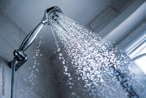 Water running from shower head and faucet in the bathroom, photo