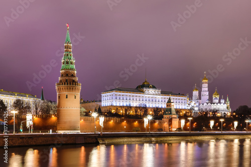 Illuminated Moscow Kremlin with Grand Kremlin Palace the government residence of president of Russia. View from the embankment of Moskva river. Evening urban landscape in the blue hour