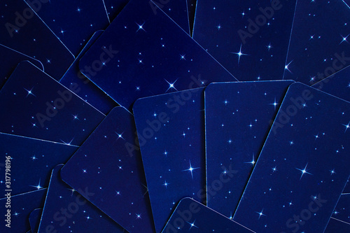 dark blue background with stars tarot reading cards deck
