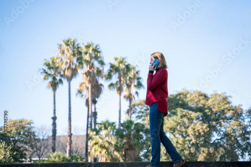 Attractive blonde woman using her smartphone