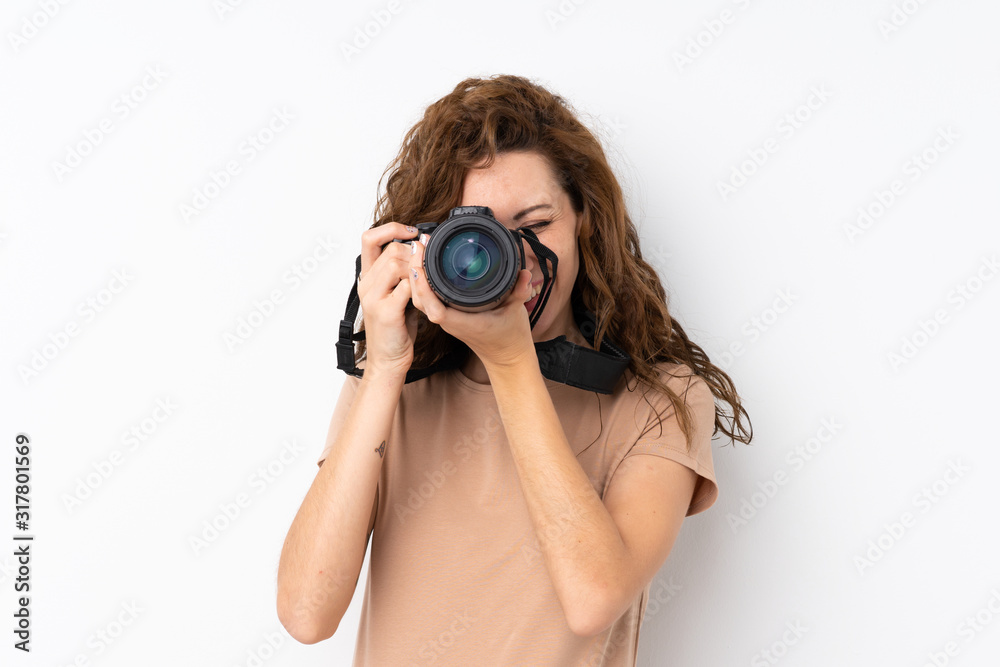 Young pretty woman over isolated background with a professional camera Young pretty woman over isolated background with a professional camera