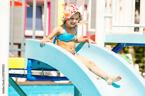 Girl Sliding in pool during Turkey vacations summer holiday