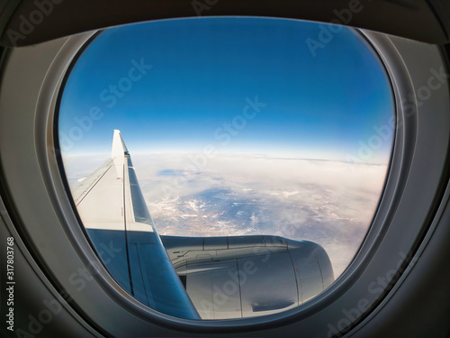 Looking out the window of a jet airplane over the wing and engine and seeing an apparent curvature of the Earth