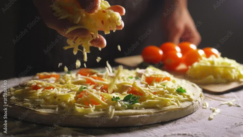 Close up view of a man chef cooking italian pizza. The process of making pizza at table in bakery. Fresh dough on kitchen table