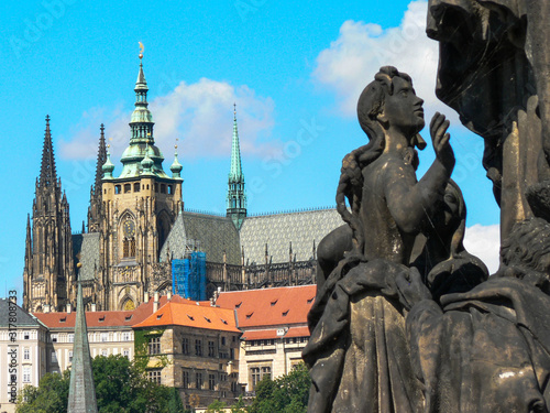 Detail of the statue of St. Cyril on the Charles Bridge in Prague with the cathedral in the background