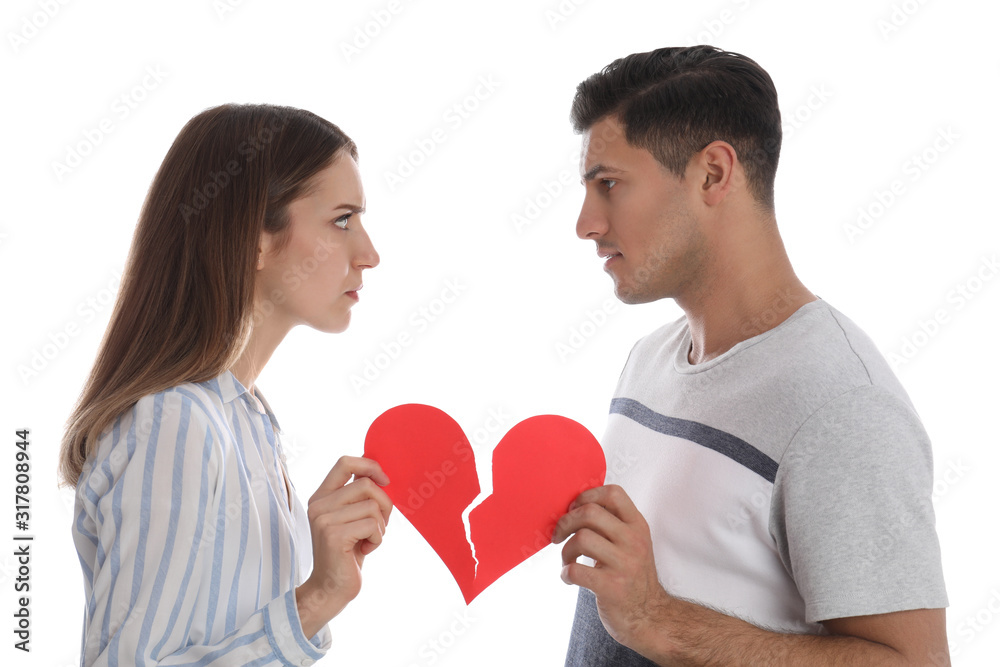 Couple with torn paper heart on white background. Relationship problems Couple with torn paper heart on white background. Relationship problems
