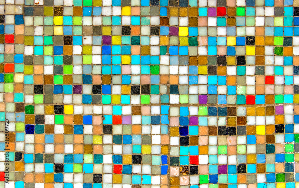 Wall with colorful mosaics  background. Multicolor squares look like pixels. background