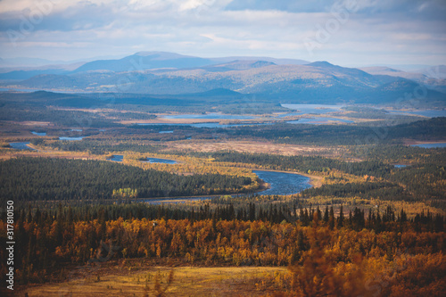 Swedish autumn fall vibrant landscape during hiking to Kurravaara mountain in Norrbotten county, Kiruna Municipality, Northern Sweden photo