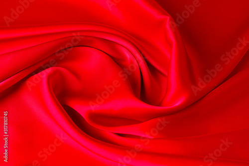 Red ruby color silk fabric background, top view