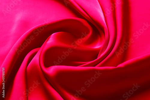 Pink color silk fabric background, top view