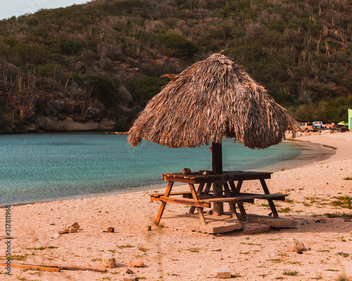 Playa Santa Cruz beach in Curacao. Bamboo beach umbrella hut.