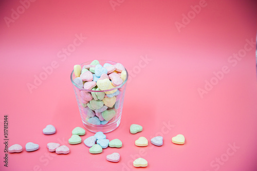 Heart shape message letter candy on pink background. Valentines day concept. 