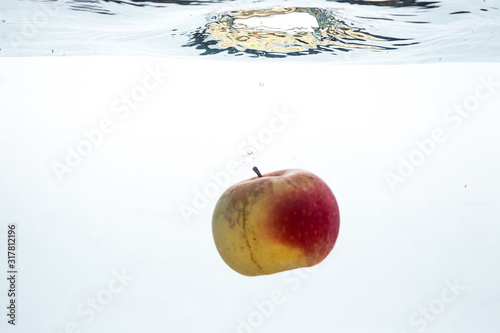  fresh Apple under water. Fruit in water. Water splashes, water splashes. Apple on a white background