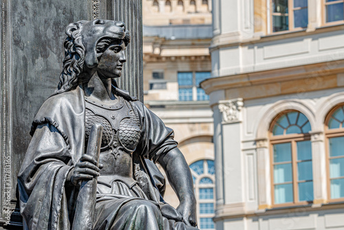 Old statue of a sensual woman warrior, Amazonian, as defender with lion head and club at the Neumarkt in downtown of Dresden, Germany, details, closeup