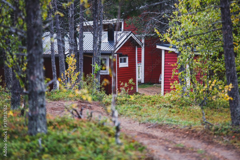 View of Classical swedish Camping site with traditional wooden red cabin cottage houses, Lapland, Northern Sweden