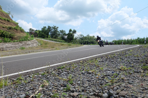 Man riding a classic motorcycle on highway of mountain