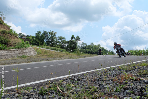 Man riding a classic motorcycle on highway of mountain