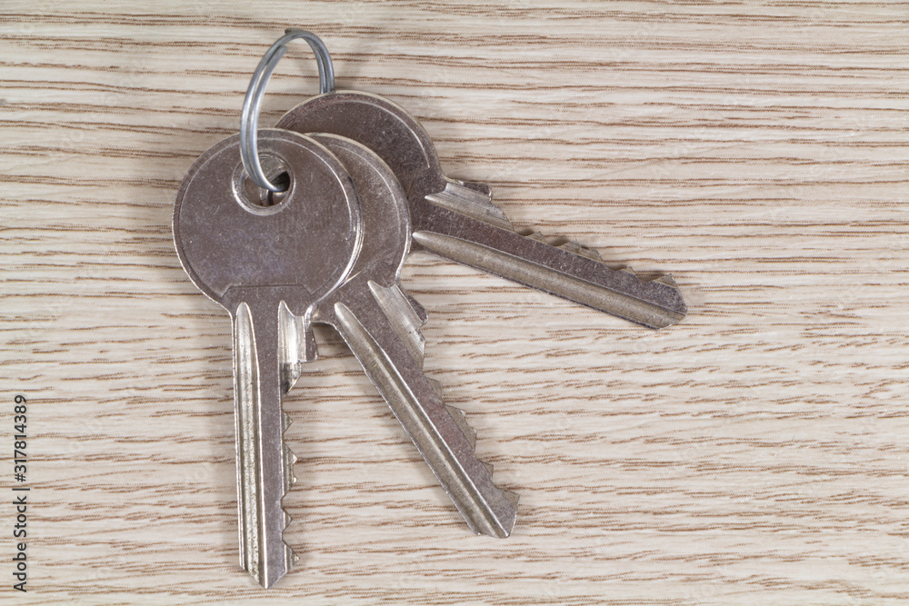 Bunches of three keys on wooden background Bunches of three keys on wooden background