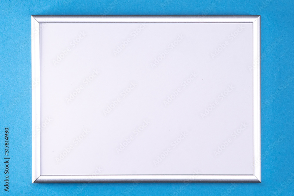 Silver frame with a white insert on a light blue background. Silver frame with a white insert on a light blue background.