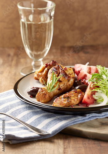 Grilled chicken pieces with fresh salad. Wooden background