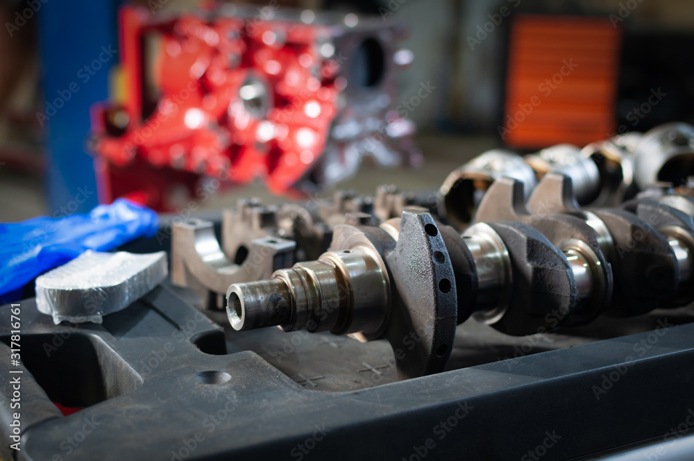 Naklejka premium car cylinder block and crankshaft in workshop. engine overhaul in a small service
