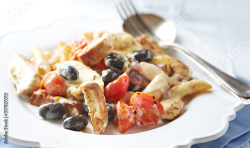  Penne pasta with fried pork tenderloin, cherry tomatoes and black olives. Oven baked.