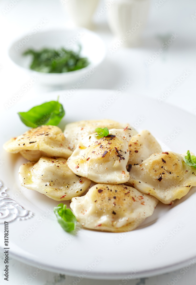 Dumplings with potato and cottage cheese stuffing (pierogi). Traditional Polish Christmas Dinner. Bright background. 