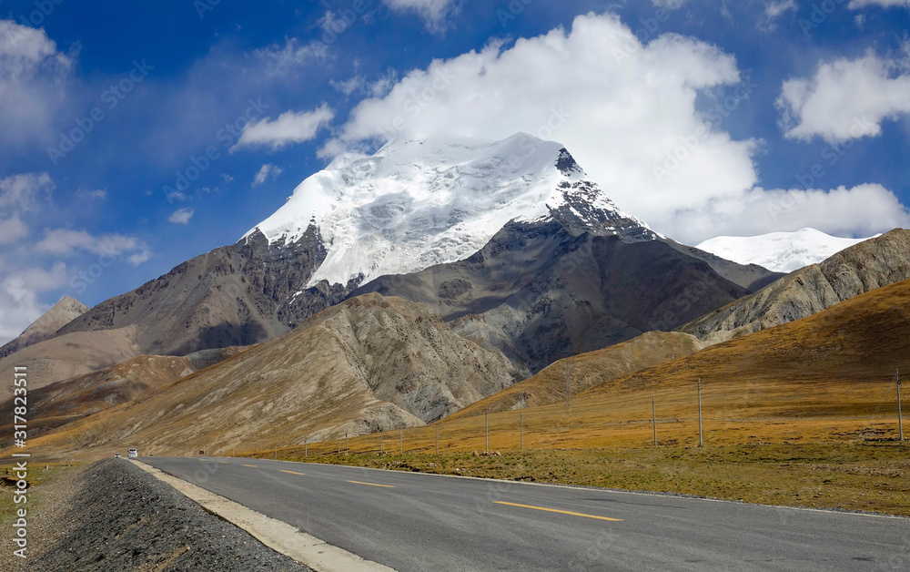 LOW ANGLE: Empty asphalt road runs past a majestic glacier in the Himalayas.