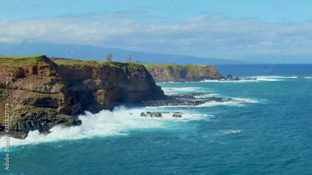 Stunning scenery of rocky coastal island splashed by ocean waves down of green hills with sharp slopes in Hawaii Stunning scenery of rocky coastal island splashed by ocean waves down of green hills with sharp slopes in Hawaii