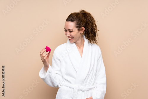Young woman in a bathrobe over isolated background