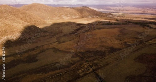 Moreno Landscape Upland Game Hunting Area. Big shade on the fields from the clouds. Aerial panorama, wide angle dolly in shot photo