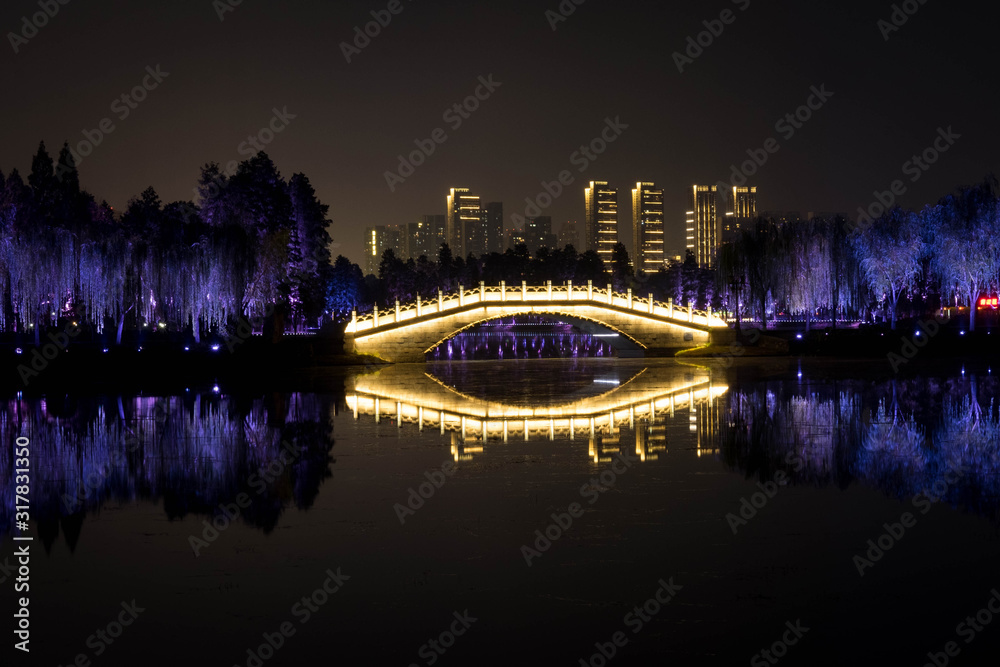 Night view of  Chinese bridge with light decoration at East Lake Wuhan, Hubei, China