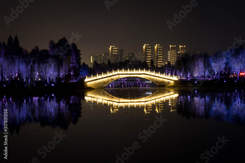 Night view of Chinese bridge with light decoration at East Lake Wuhan, Hubei, China