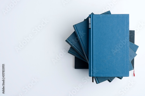 Classic blue book stack on the right side. top view, white background, top view