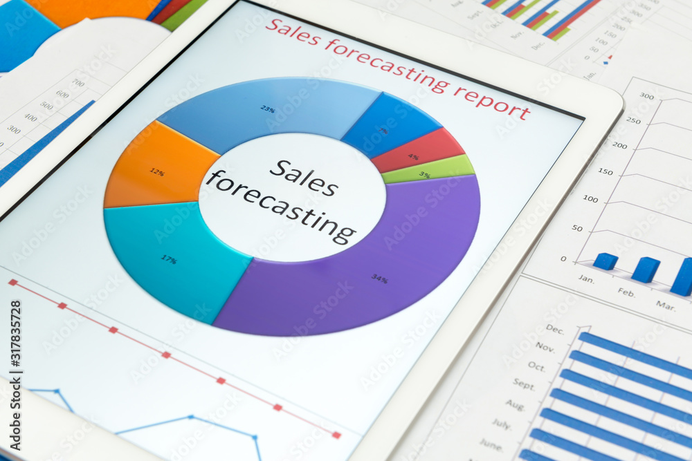 Financial charts on the table with tablet Financial charts on the table with tablet