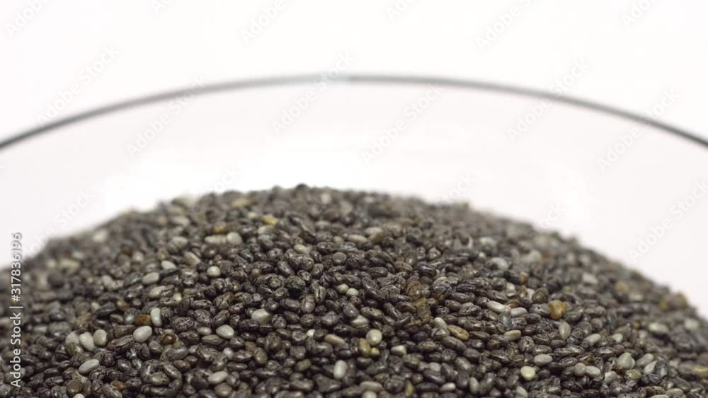 Close up of chia seeds in rotation isolated on white Close up of chia seeds in rotation isolated on white