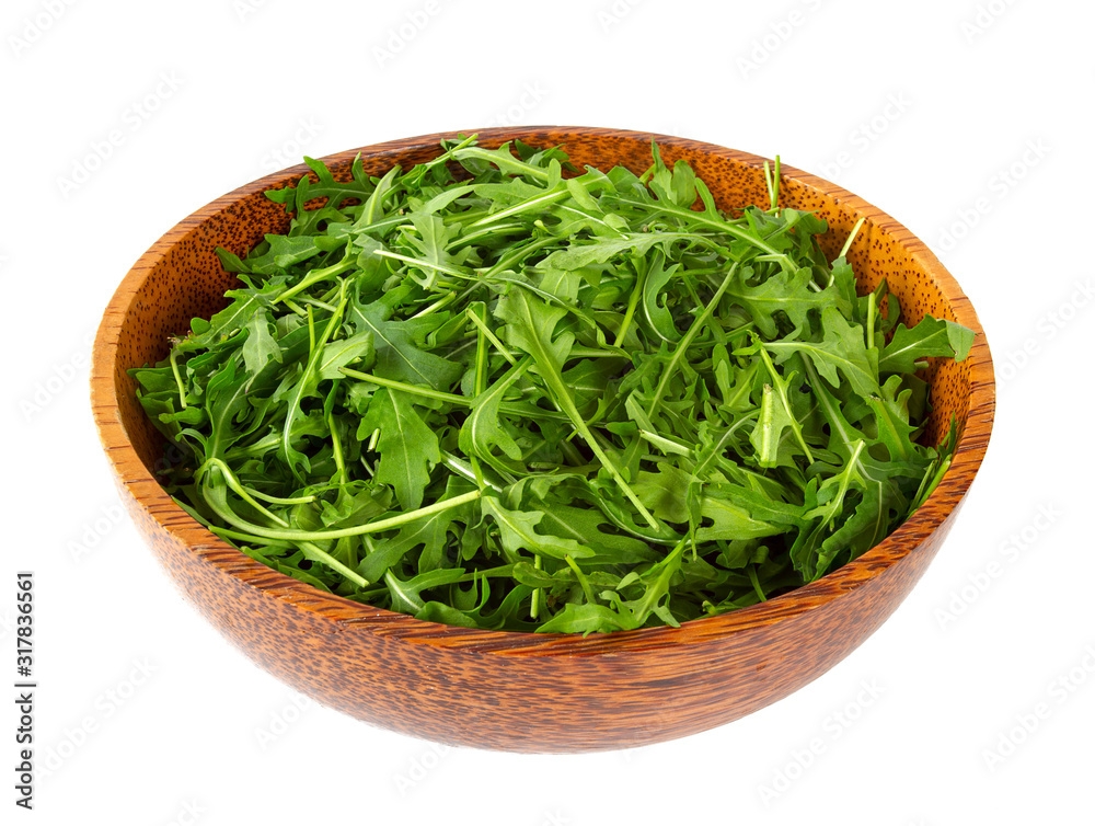 Arugula leafs in a wooden bowl Arugula leafs in a wooden bowl