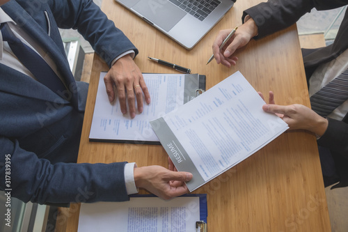 Apply for a job with a resume and search for qualified employees to screen jobs on a computer desk.