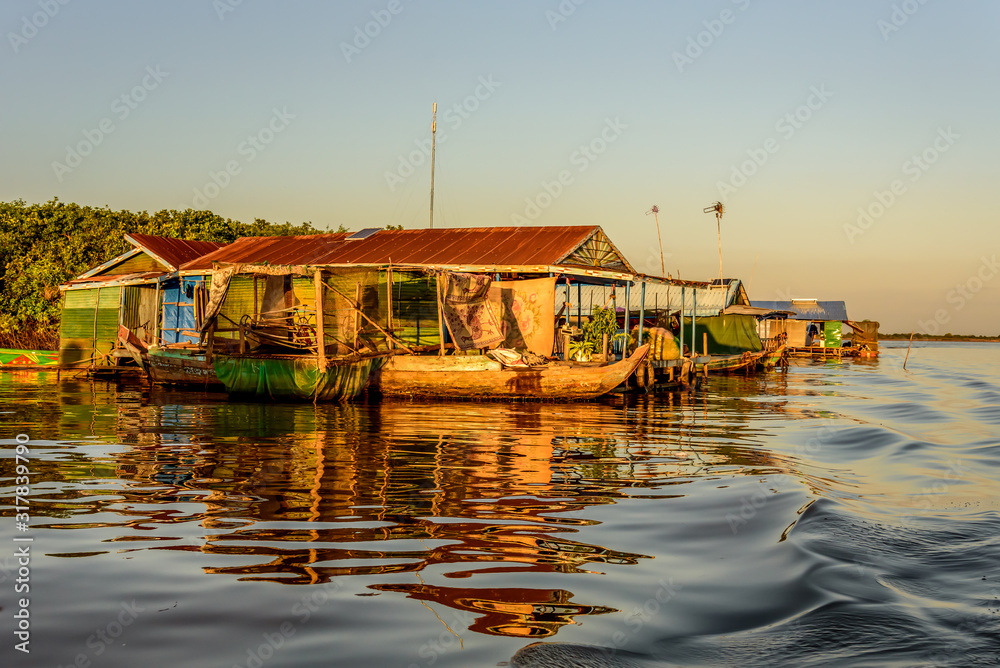 Fototapeta premium The Floating Village of Kampong Khleang on Tonle Sap Lake at Siem Reap Cambodia During Sunset