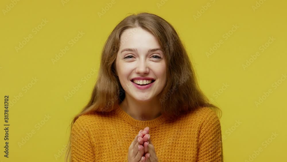 Closeup of sincere beautiful girl covering her mouth with hands and peering into camera in surprise, expressing genuine astonishment, disbelief. indoor studio shot isolated on yellow background Closeup of sincere beautiful girl covering her mouth with hands and peering into camera in surprise, expressing genuine astonishment, disbelief. indoor studio shot isolated on yellow background