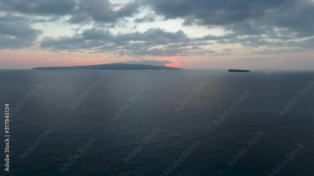 Sunset over Kahoolawe with alalakeiki shot from Big Beach Maui, aerial view Sunset over Kahoolawe with alalakeiki shot from Big Beach Maui, aerial view
