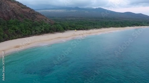 Big Beach Maui Hawaii with people playing in the sand and water, aerial view photo