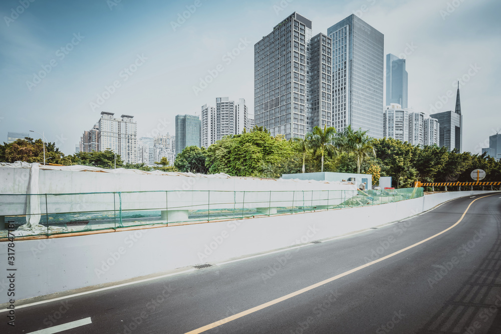 Fototapeta premium empty road with zebra crossing and skyscrapers in modern city
