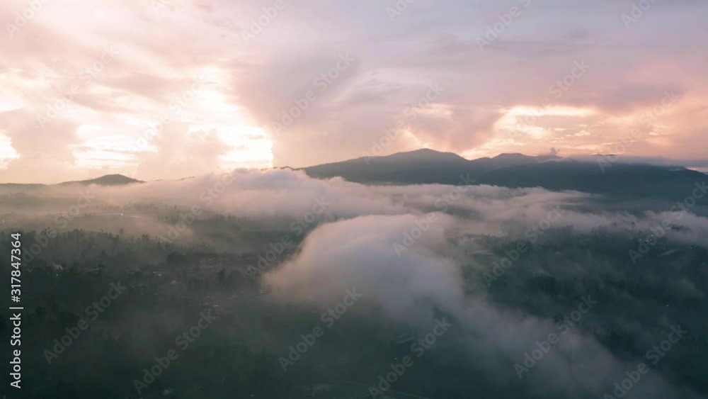 Beautiful aerial view of sky with fluffy clouds and mountain background at sunrise time. Shot in 4k resolution from a drone flying forwards Beautiful aerial view of sky with fluffy clouds and mountain background at sunrise time. Shot in 4k resolution from a drone flying forwards